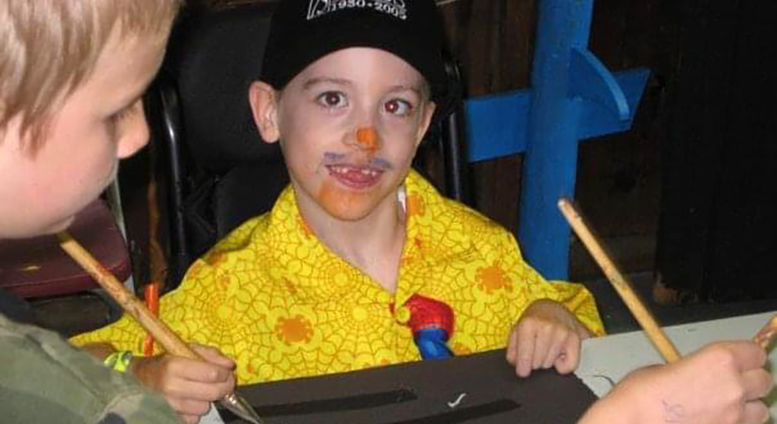 Logan painting at camp