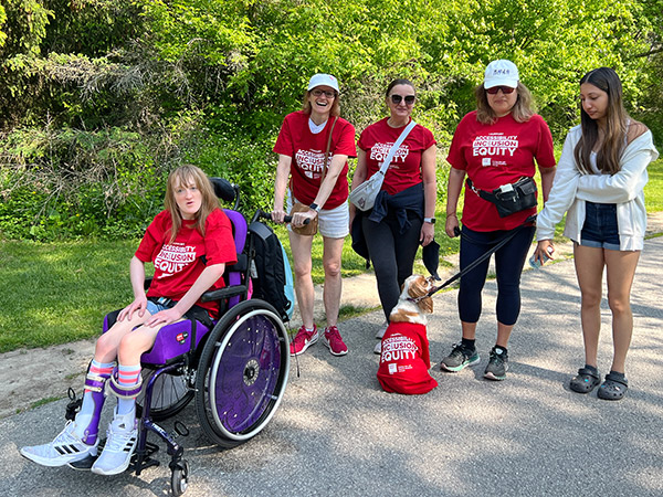 A family poses in their red shirts.